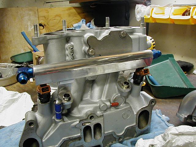 Fuel rail 2.0.  Ben made it with smaller o-ring bores for better fitting and sealing.

**EDIT**  Don't cap the line in blue, l
