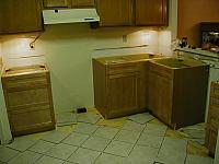 Got the new base cabinets in, and leveled, and some tile laid.