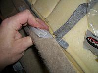 The OEM cover has this long piece that clips over the seat frame.